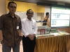 Mr.Harris Fadillah of UNIDO and Mr.Wiharja of BPPT, as a member of AGC assessor pictured with background of participant’s presentation and their factory miniature.